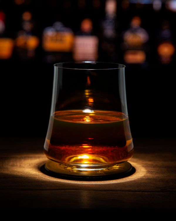 Glass of Scotch whisky in a classic bar setting