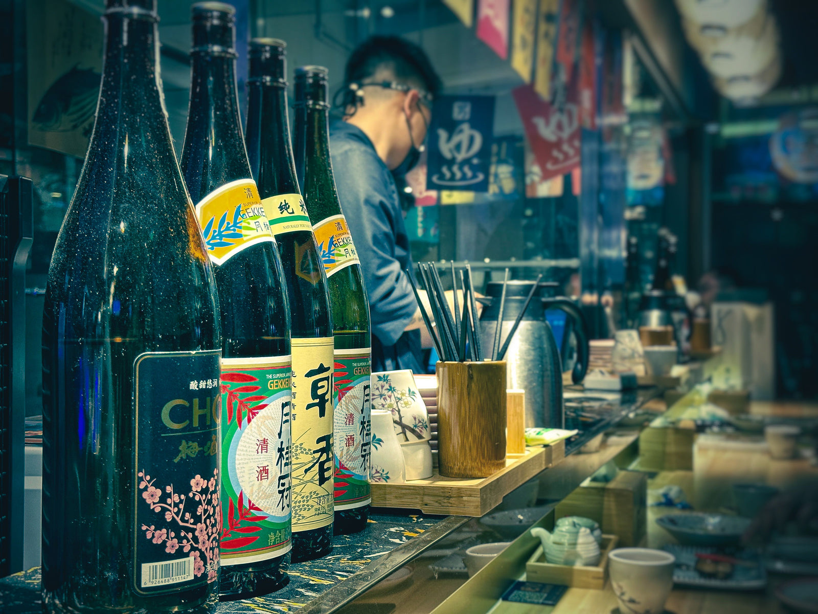 Sake and Japanese spirits bottles at an izakaya bar