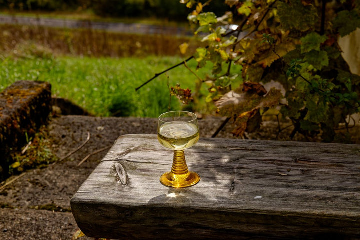 Wine glass on a rustic outdoor table at a New York vineyard