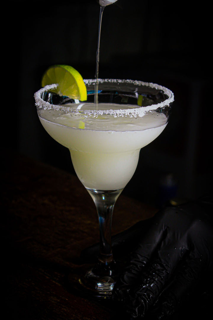 Classic frozen margarita with salt rim and lime slice