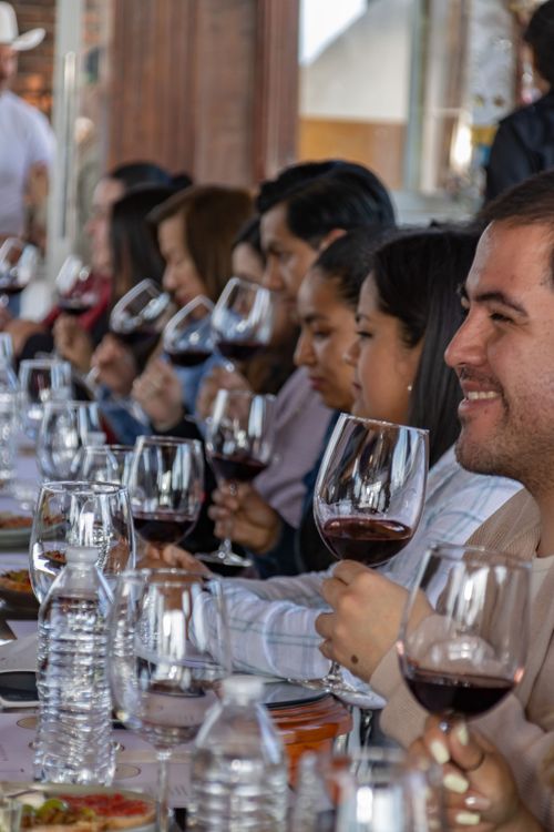 Diverse group of people enjoying a wine tasting event together