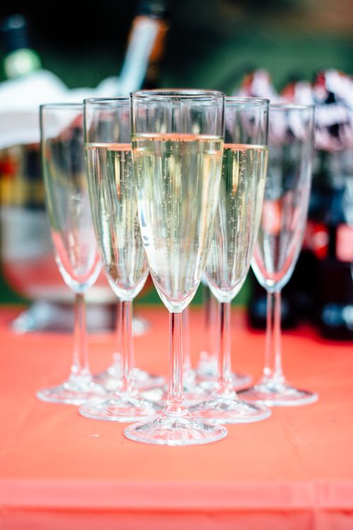 Close-up of elegant champagne glasses clinking at a wedding celebration