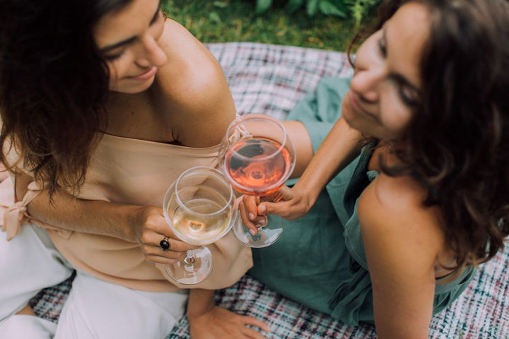 Overhead shot of women toasting with wine glasses at a celebration