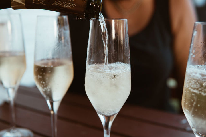 Champagne being poured into elegant flute glasses with bubbles