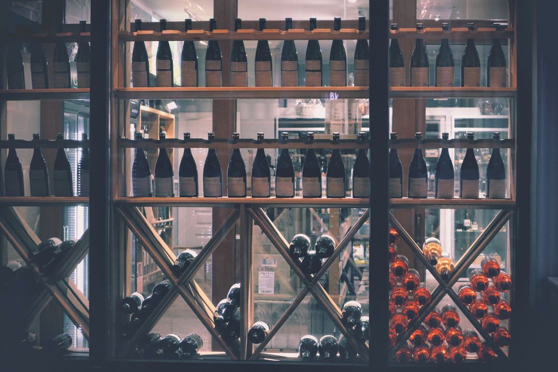 Wine bottles displayed on shelves in a well-stocked liquor store