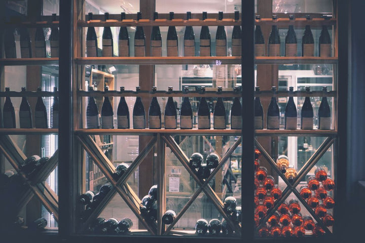Wine bottles displayed on shelves in a well-stocked liquor store