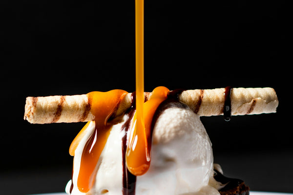Bourbon cocktails on a bar with garnishes