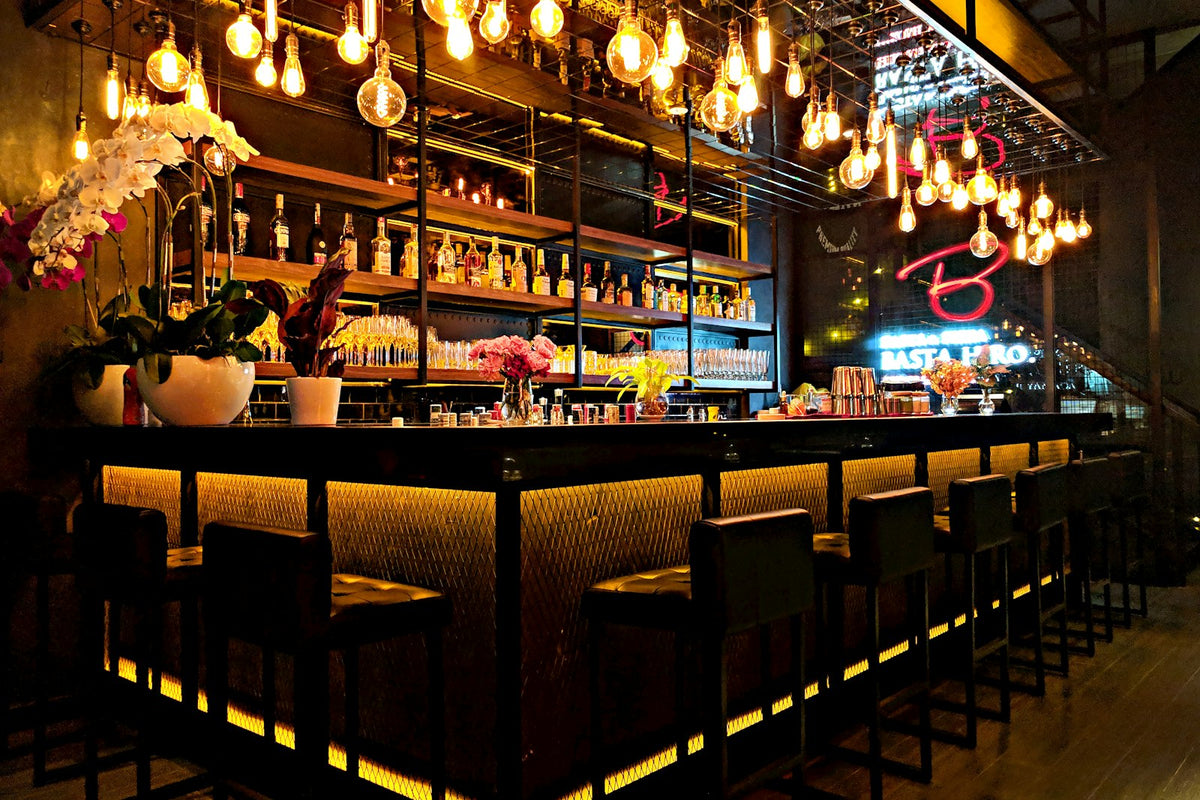 Bourbon Old Fashioneds on a home bar with garnishes